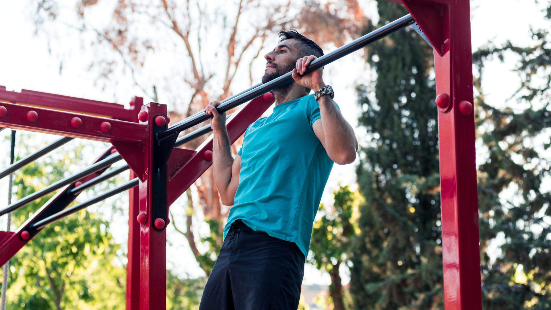 A man doing a calisthenics workout performing pull ups