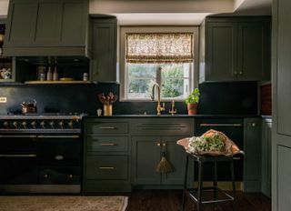 Green and gray colored kitchen with brass