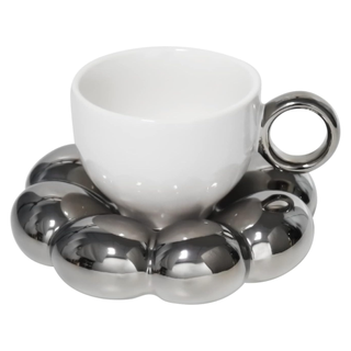A white cup and chrome saucer set