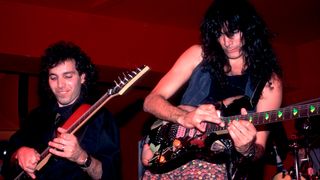 American Rock musicians Joe Satriani (left) and Steve Vai play guitars as they perform onstage the Limelight, Chicago, Illinois, June 27, 1987.