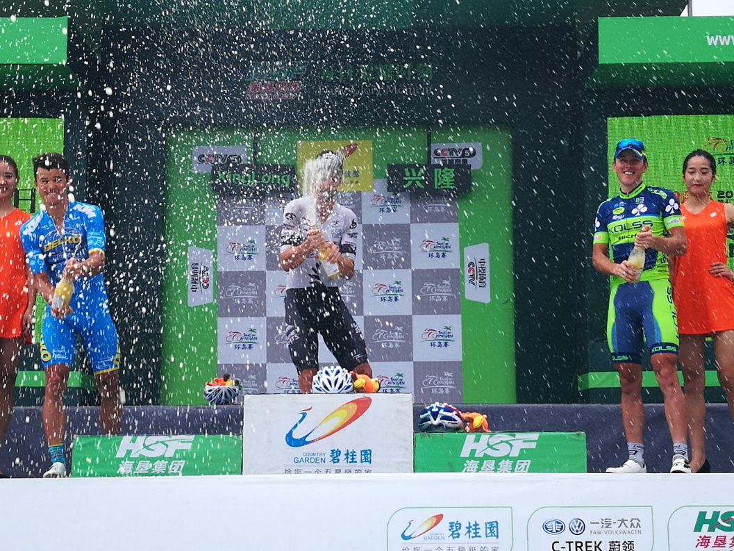 Joe Cooper celebrates on the podium at the Tour of Hainan.