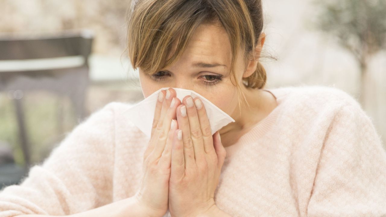 Woman sneezing