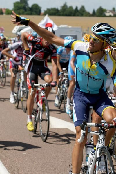 Alberto Contador reaches for his musette bag in the feed zone.