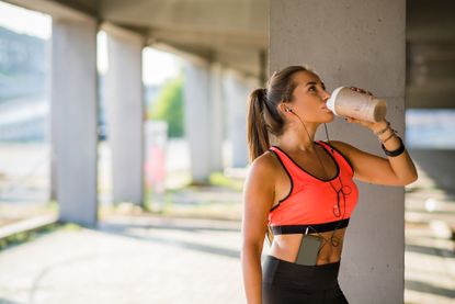 What is protein? A woman drinks a protein shake after working out
