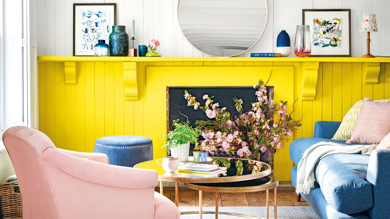 grey and yellow living room with blue sofa circular mirror and coffee table