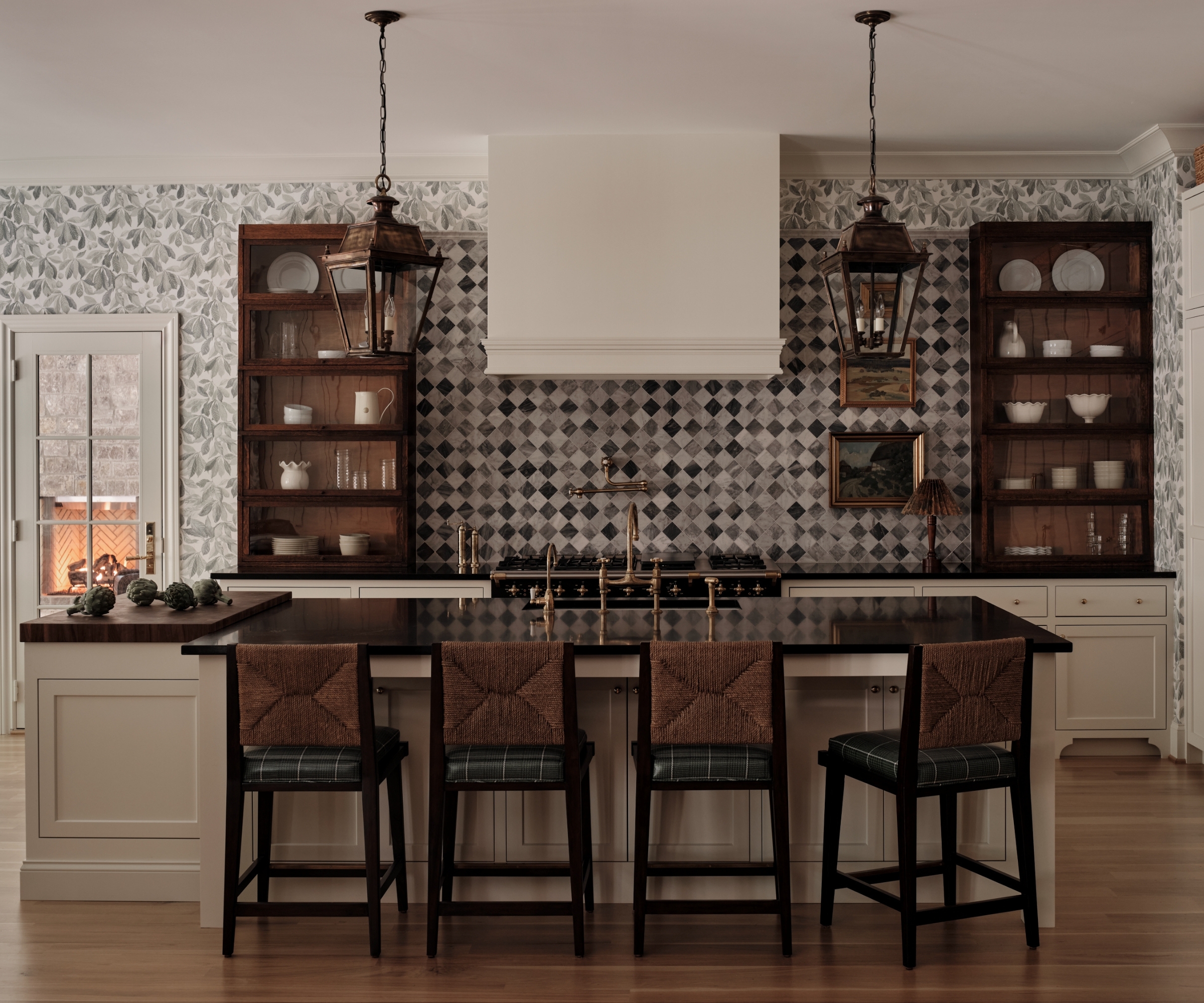 A playful kitchens with warm white cabinets, walnut counter cabinets, a diamond patterned backsplash and botanical wallpaper on the walls