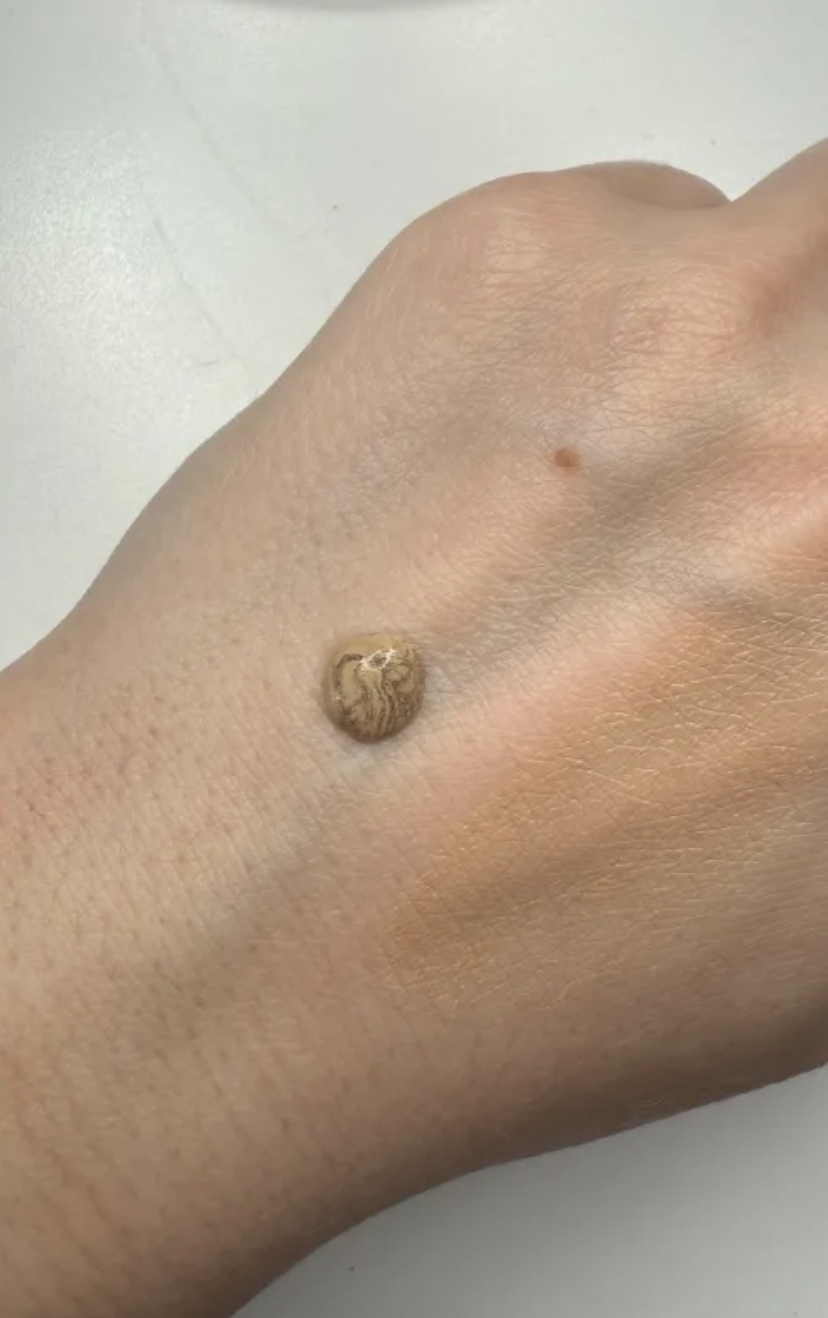 a drop of Chanel Les Beiges Water-Fresh Complexion Touch on top of a hand.