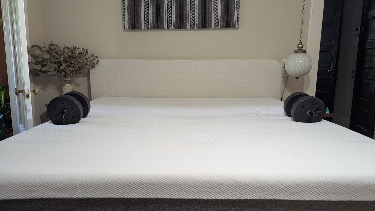 Two dumbbells placed on either edge of Sleep Number i8 smart mattress