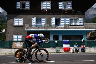 Soudal Quick-Step's French rider Remi Cavagna cycles past a chalet during the 16th stage of the 110th edition of the Tour de France cycling race, 22 km individual time trial between Passy and Combloux, in the French Alps, on July 18, 2023. (Photo by Anne-Christine POUJOULAT / AFP)