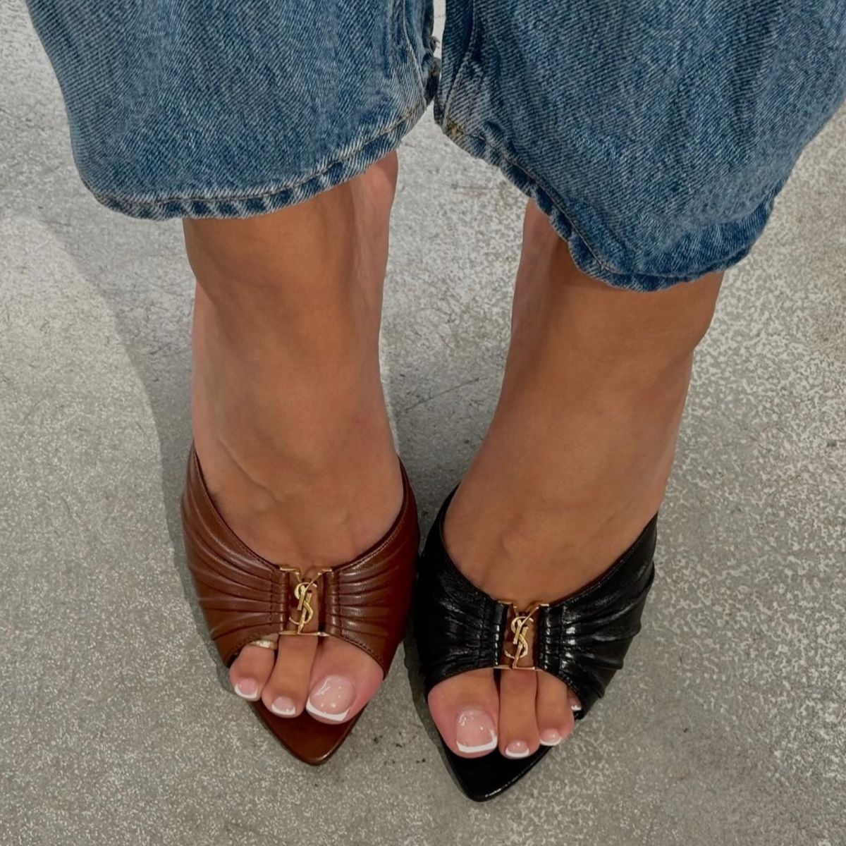 A woman wearing YSL heels with a sheer, French tip pedicure