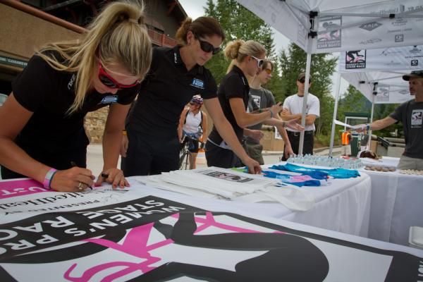 Alison Tetrick-Starnes (left) Cari Higgins (center) and Kristen McGrath sign commerative jerseys and posters for the Aspen Pro Women's Stage Race.