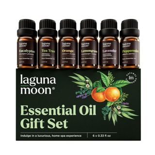 A green box of essential oils that says 'Lagunamoon essential oil gift set' with six brown bottles with black labels