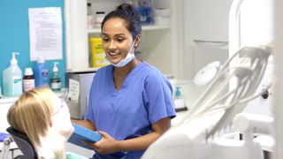 Female dentist talking to a patient in her clinic