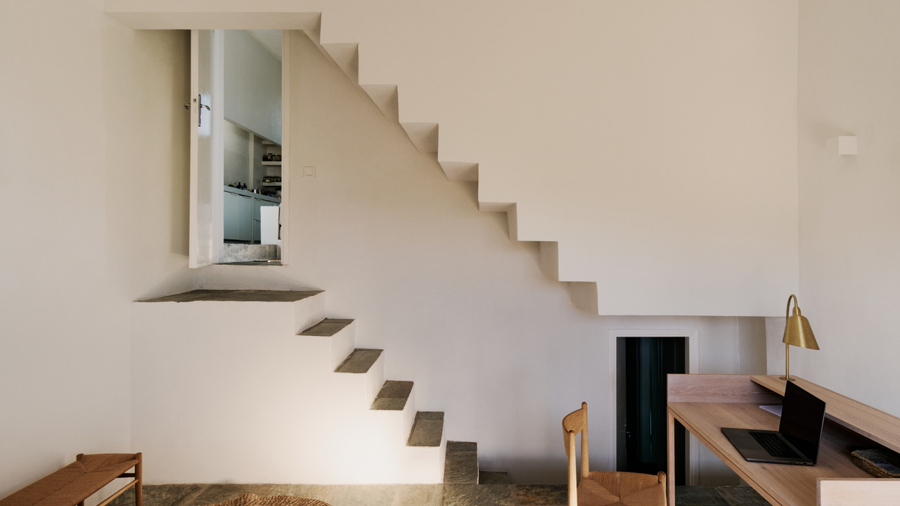 Internal space showing living space, desk and stairwell in Piperi House, located on small peninsula that projects out from the Kythnos Island