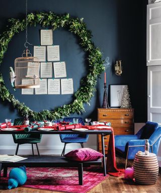 Blue dining room, rug, dining bench, table runner, garland, wreath, bird cage