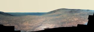 This enhanced-color view of Marathon Valley, with Endeavour Crater in the background, is a composite of many images captured by NASA’s Opportunity Mars rover during April and May 2016. The panorama spans from north (left) to west-southwest.