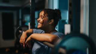 Woman smiling while weight lifting