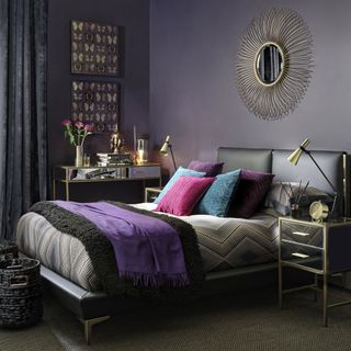 bedroom with purple walls and bed with pillows