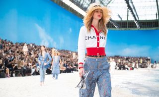 Model wear red and white jacket with light blue lace trousers and straw hat