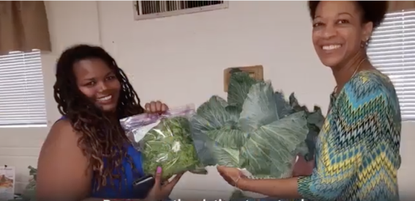 Women holding fresh vegetables.