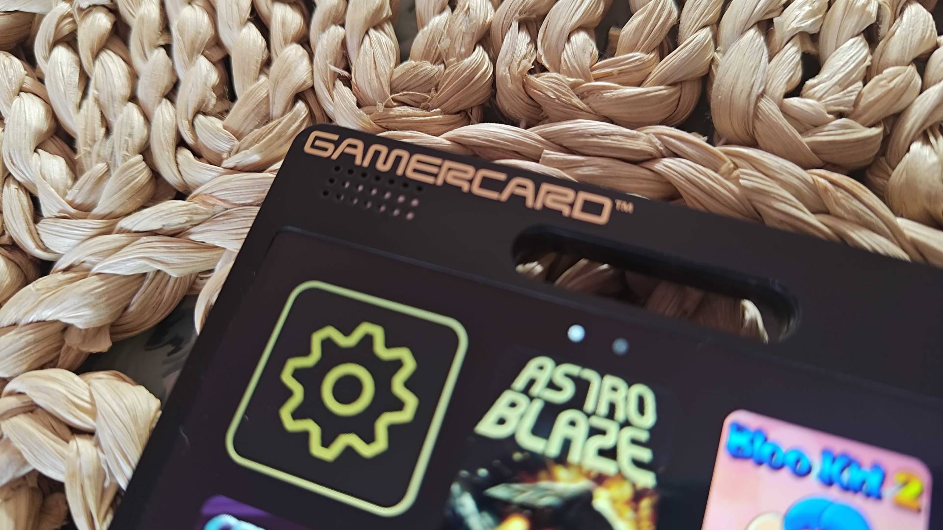 Close up of Gamercard logo on top of handheld.