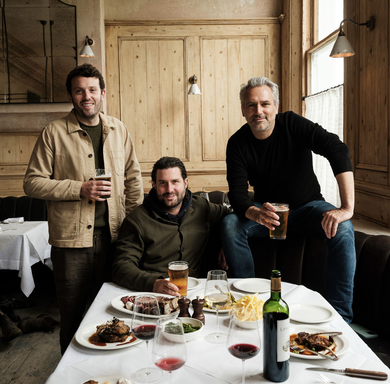 Public House Group founders sharing a pint and some food at the Hero in Maida Vale