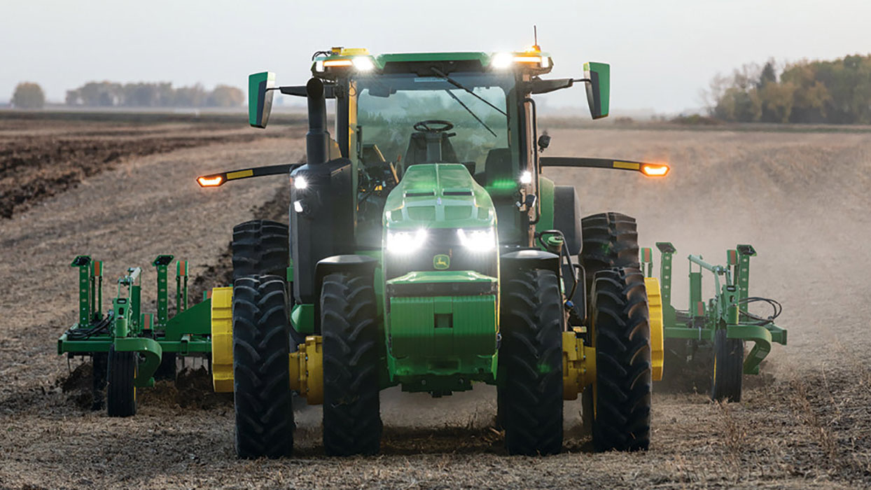 An autonomous John Deere tractor working a field