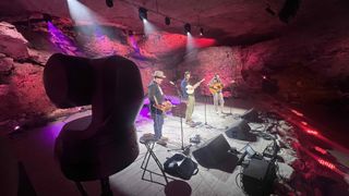 Cameras capture musicians in a cave.