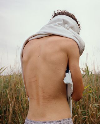 Man with bare back in a field
