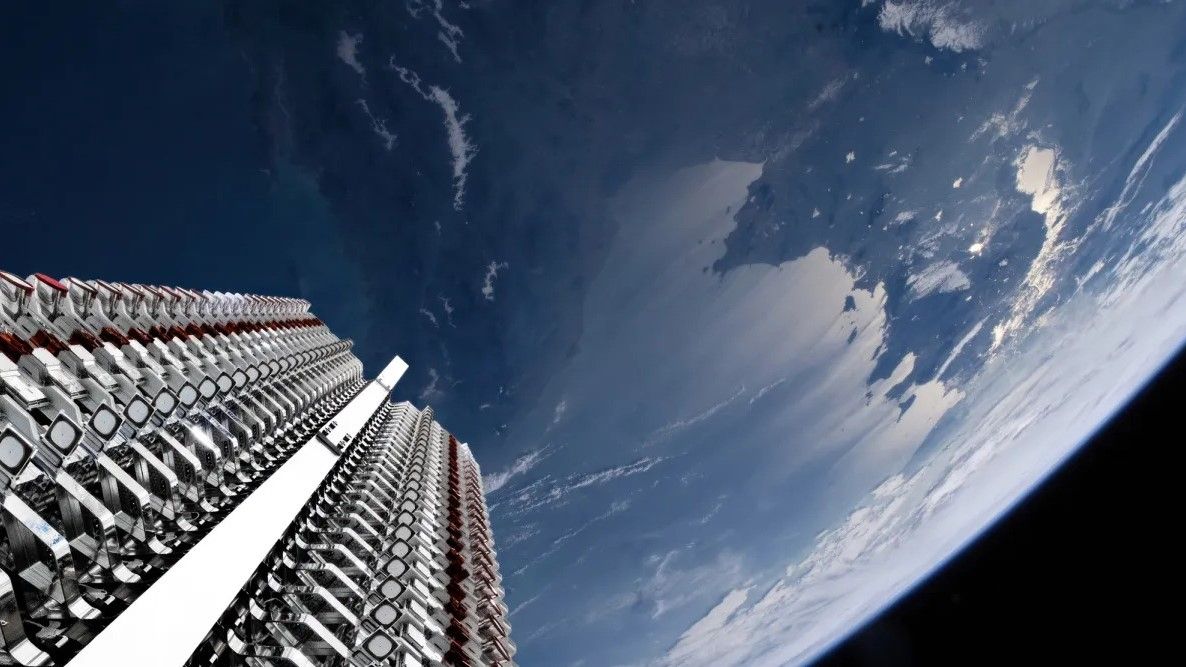 view from the upper stage of a rocket looking down at its closely packed satellite payload and Earth in the background