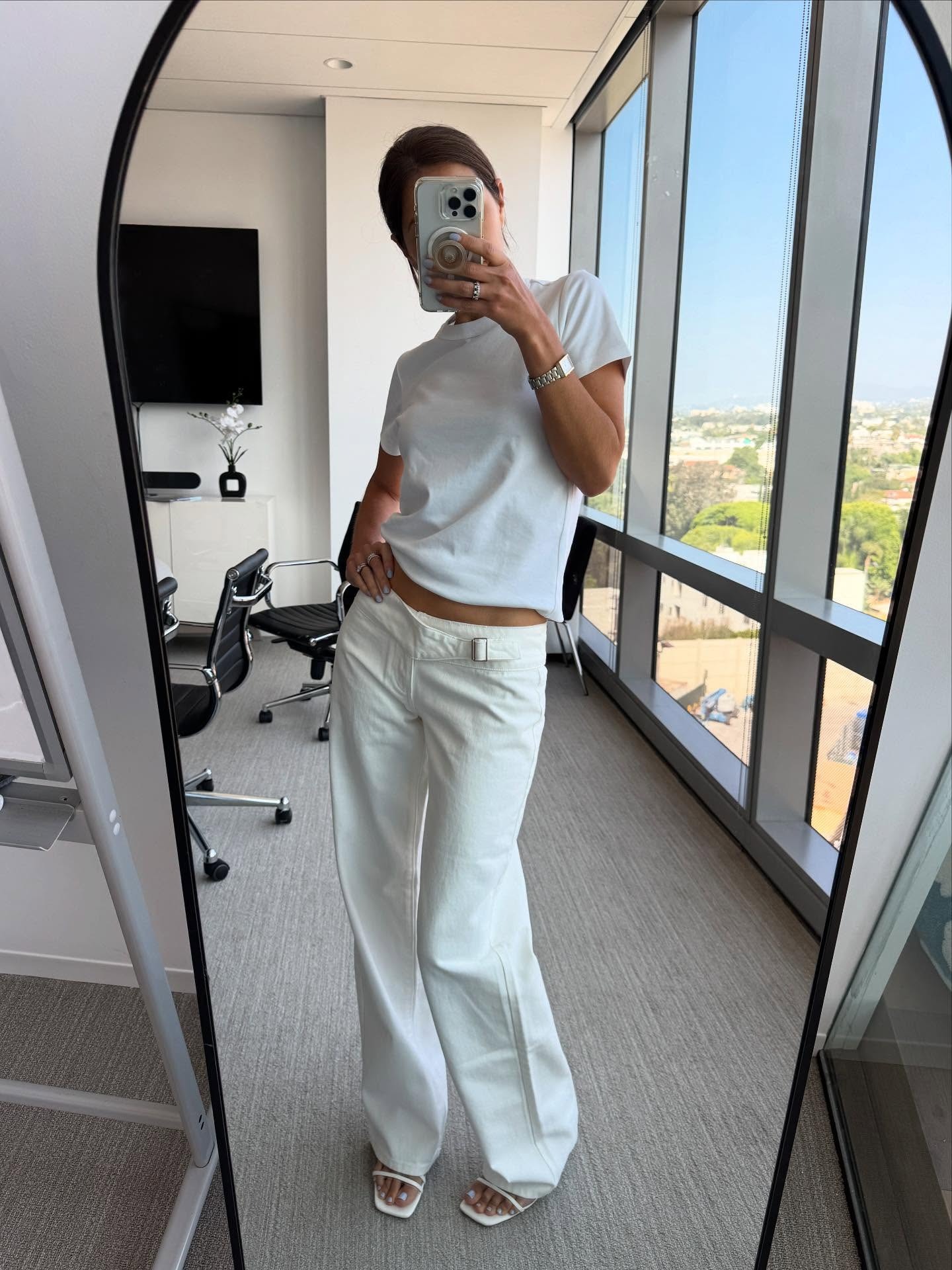 Woman in white low rise jeans and t-shirt