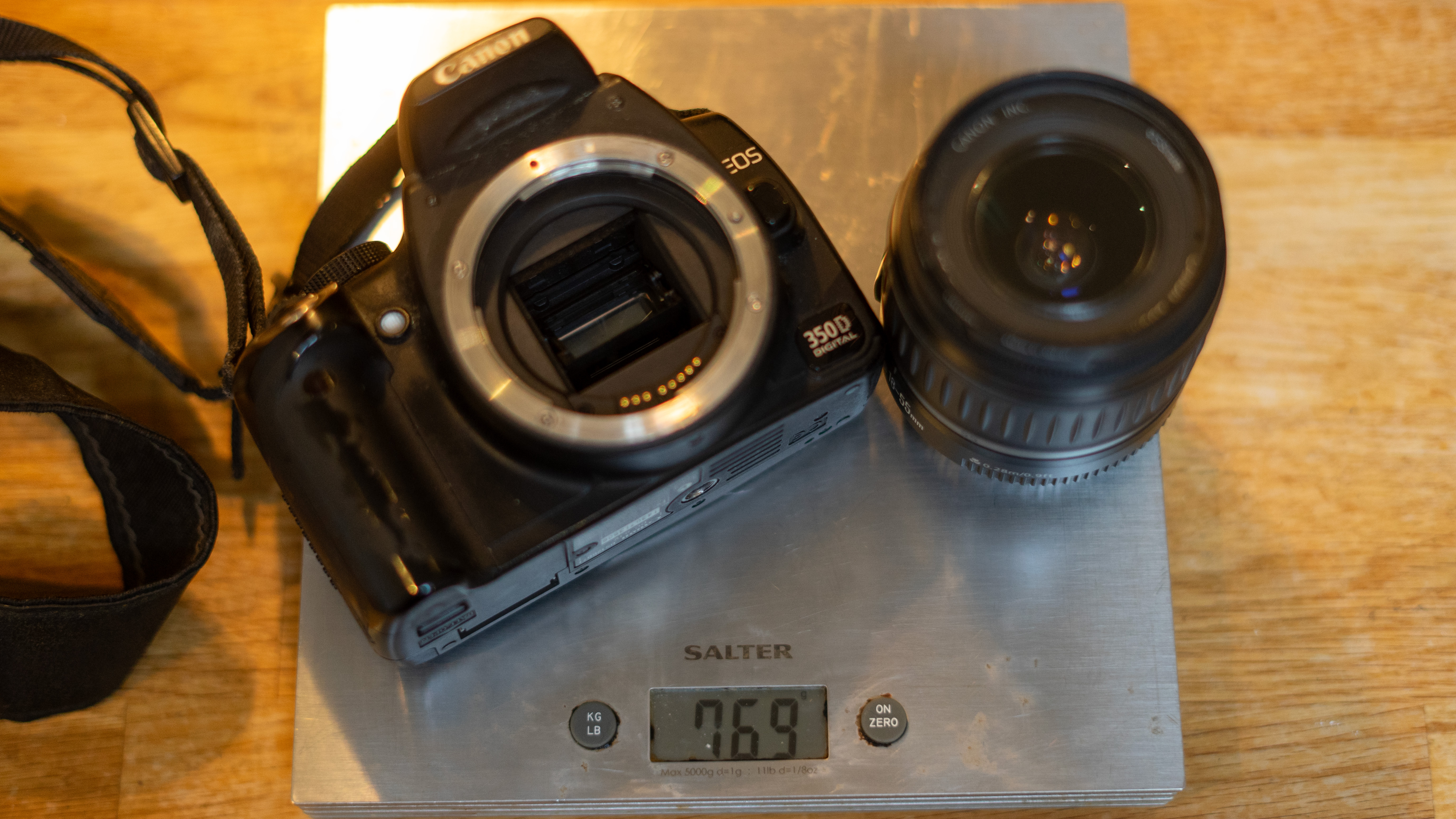 DSLR on scales with lens off to reveal mirror – scales show 769g