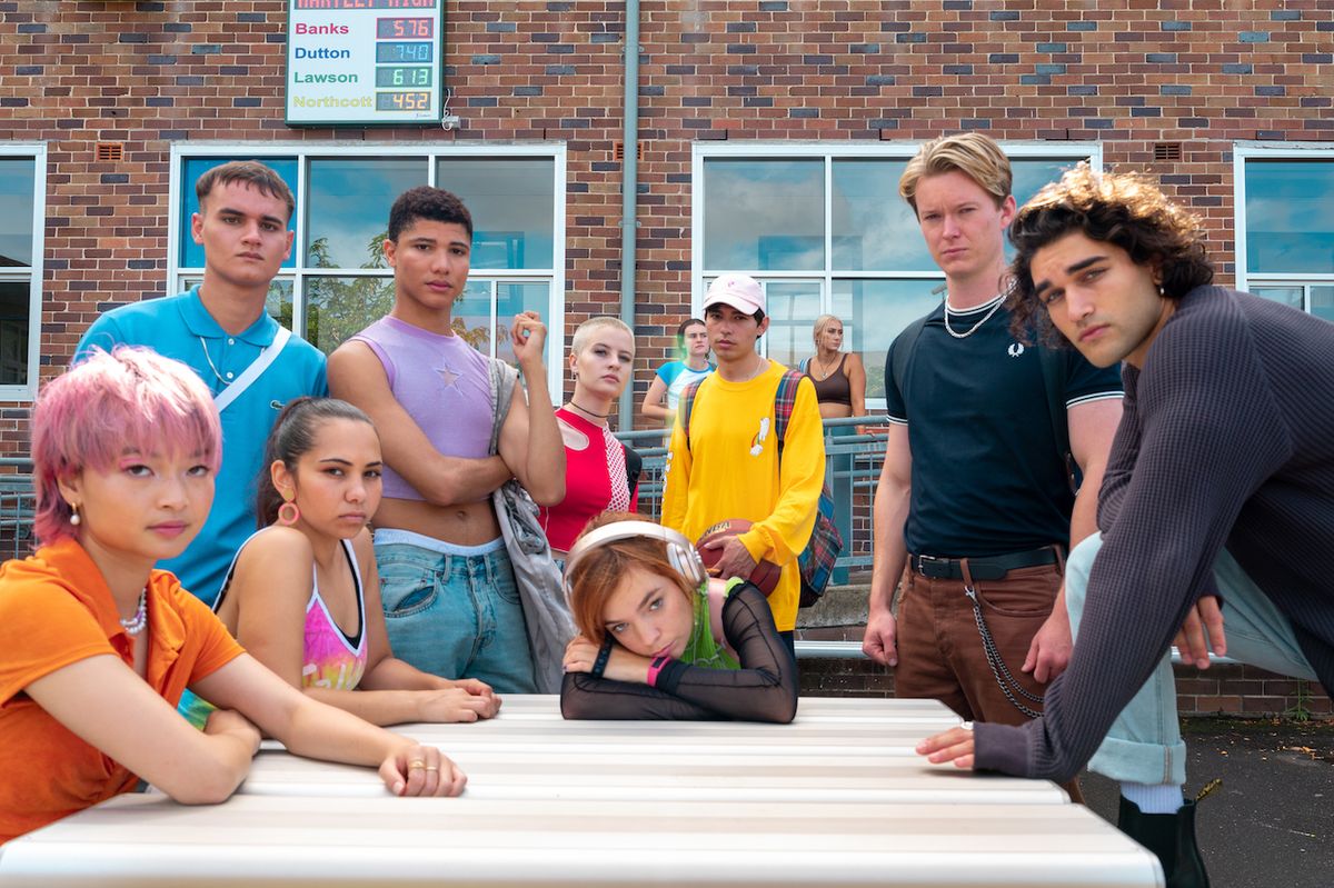 Heartbreak High cast sitting around a table at school.