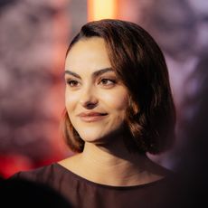 a close up red carpet photo of a latina woman with short brown hair