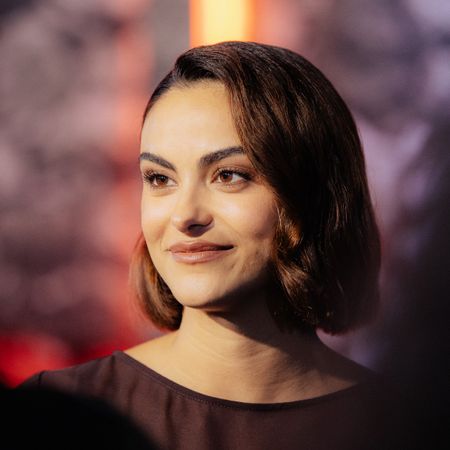 a close up red carpet photo of a latina woman with short brown hair
