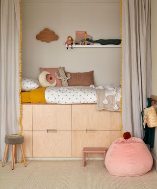 child's bedroom with raised storage bed and carpet flooring
