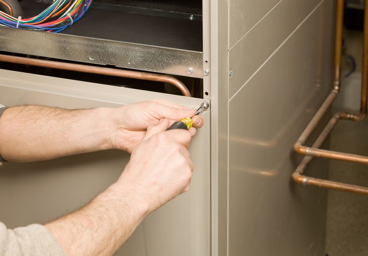 An electrician installing a furnace