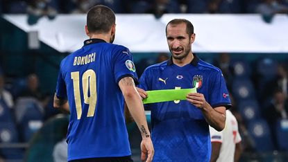 Italy captain Giorgio Chiellini passes the armband to Leonardo Bonucci 