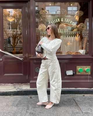 Woman wearing white barrel-leg jeans