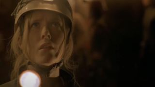 Shauna Macdonald as Sarah shining a light in a cave in The Descent