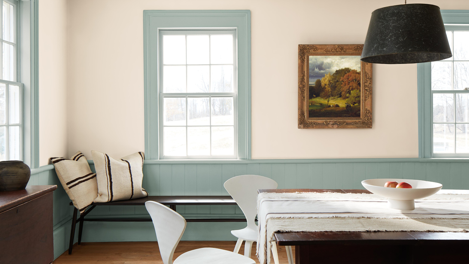 dining room with pale blue panelling, blue window frames and off-white walls