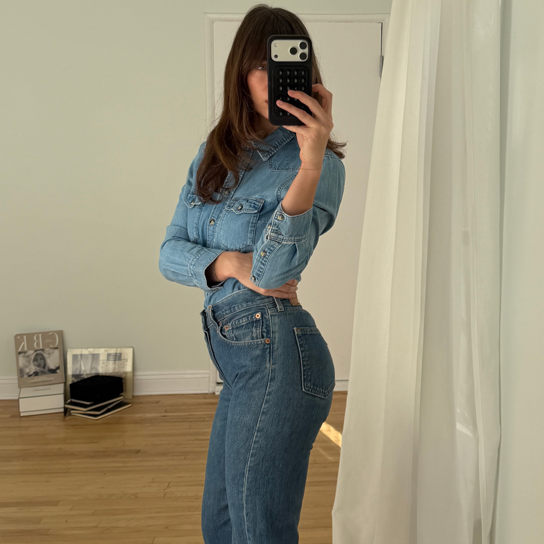 Kathryn Zahorak posing in mirror wearing denim shirt and jeans