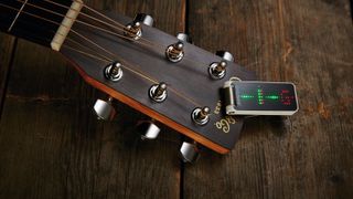 Clip on guitar tuner on an acoustic guitar