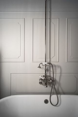 A white bathroom with wall panelling