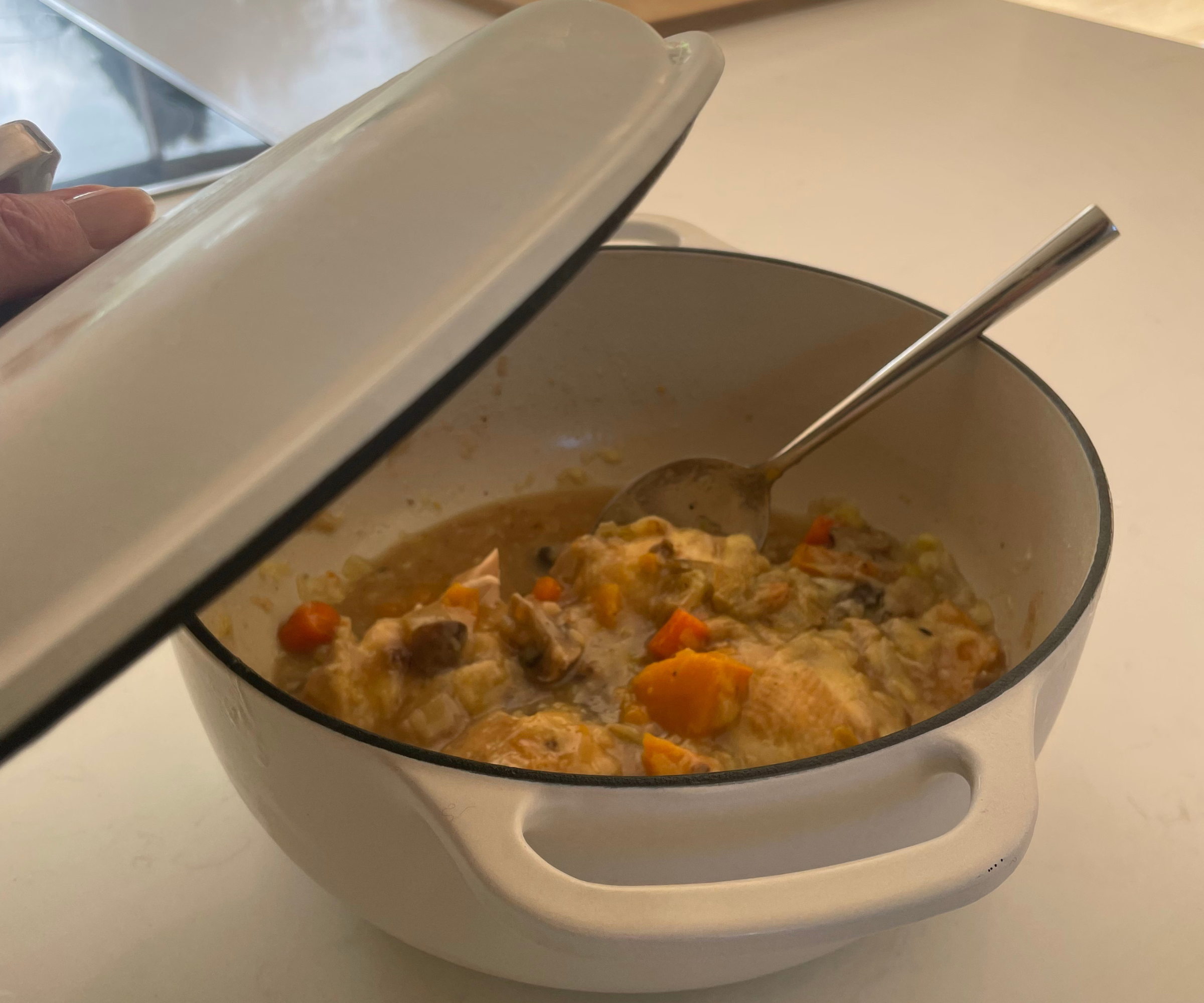 Sizzling chicken thighs and diced vegetables in the Lodge 6QT Enameled Cast Iron Dutch Oven with Lid in my test kitchen