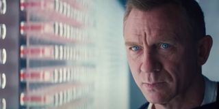 No Time To Die Daniel Craig staring angrily at a wall of vials