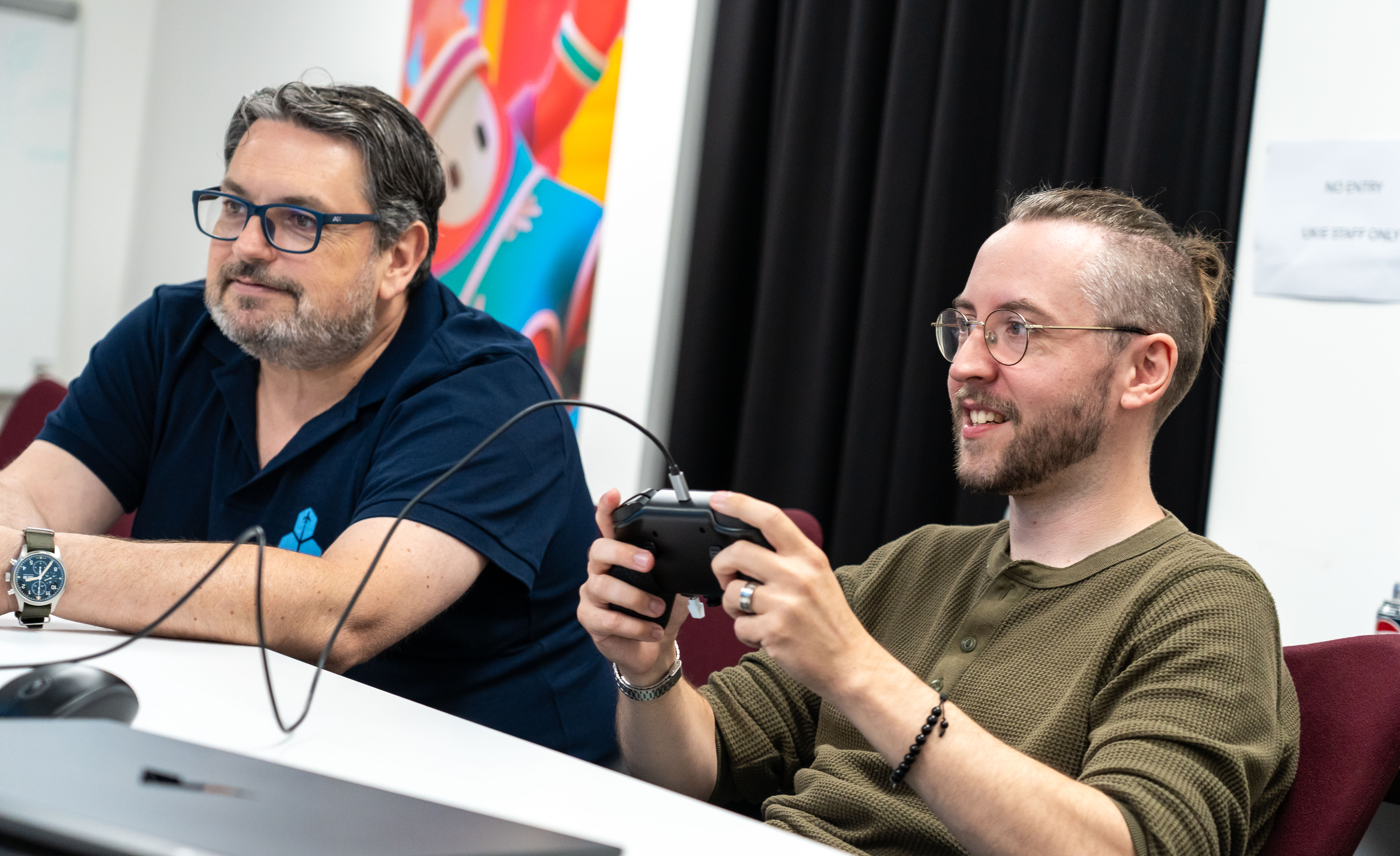 snakebyte | GROUP CTO Marc Küpper (left) watches as Windows Central Senior Editor Ben Wilson (right) uses a Honeycomb Aeronautical Echo Avitaion Controller prototype.
