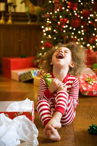 Excited child opening Christmas gift