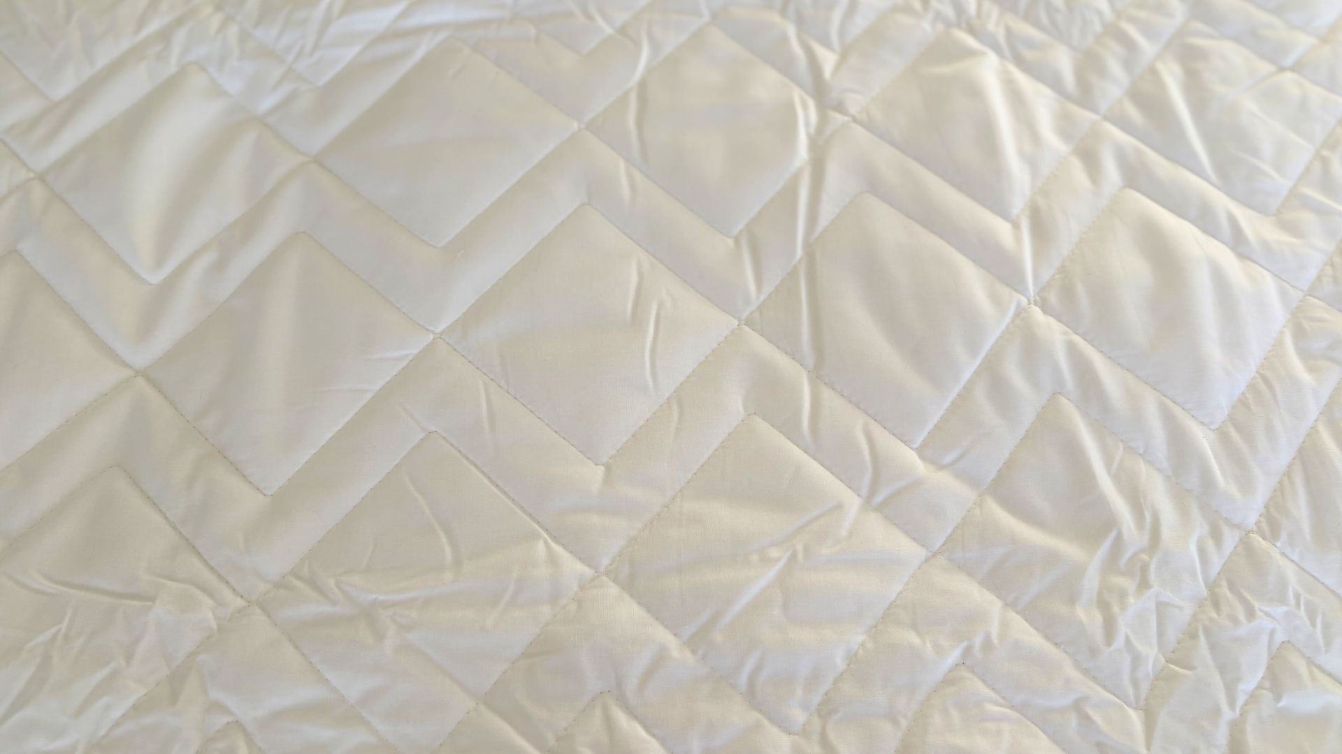 Simba Performance Mattress Protector being tested, on the bed