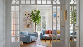 A light blue couch with wooden floor